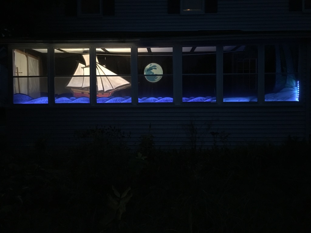 porch window with the full moon rising over the sea and a pirate ship