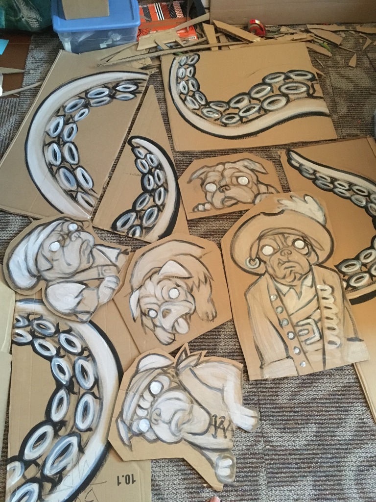 rough line paining on cardboard of pugs in pirate costumes and tentacles