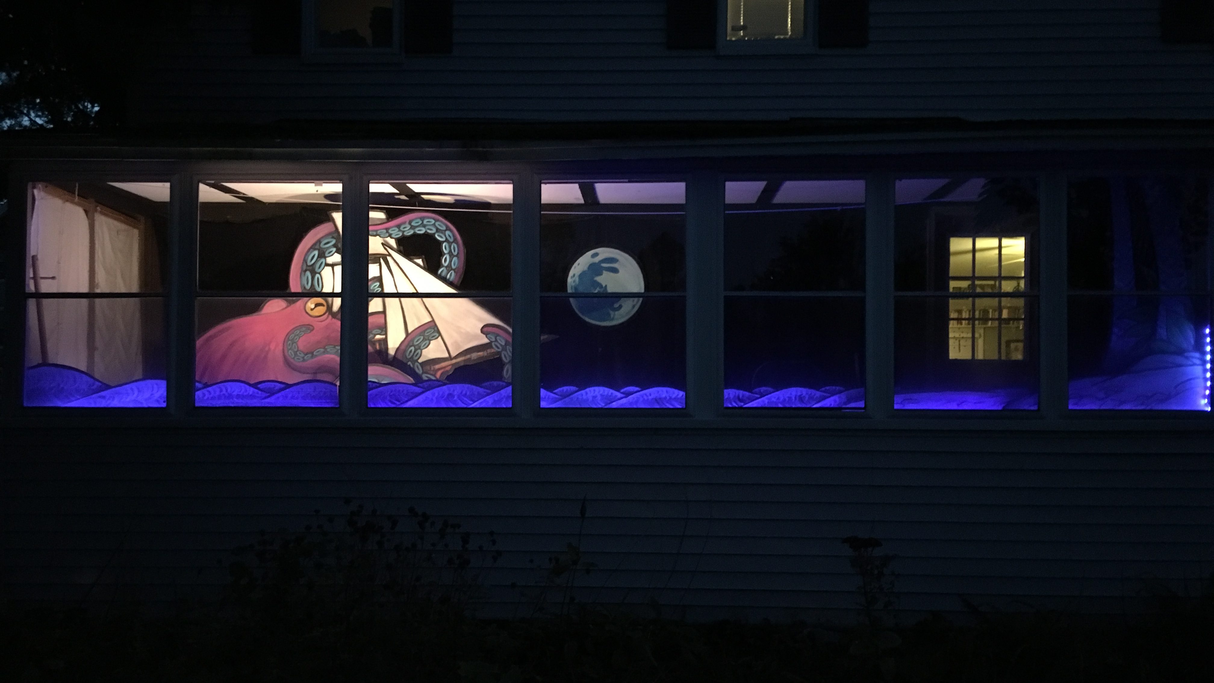 porch window with the full moon rising over the sea, a pirate ship, and a giant octopus attacking the ship