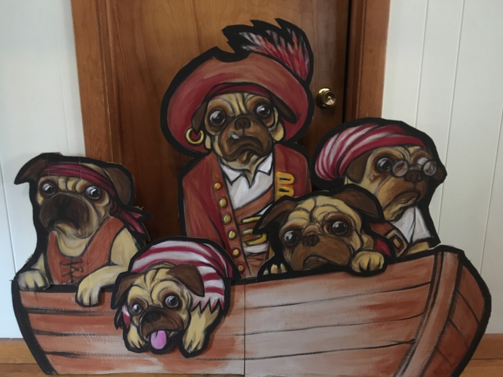 pus dressed as a pirate crew in a lifeboat